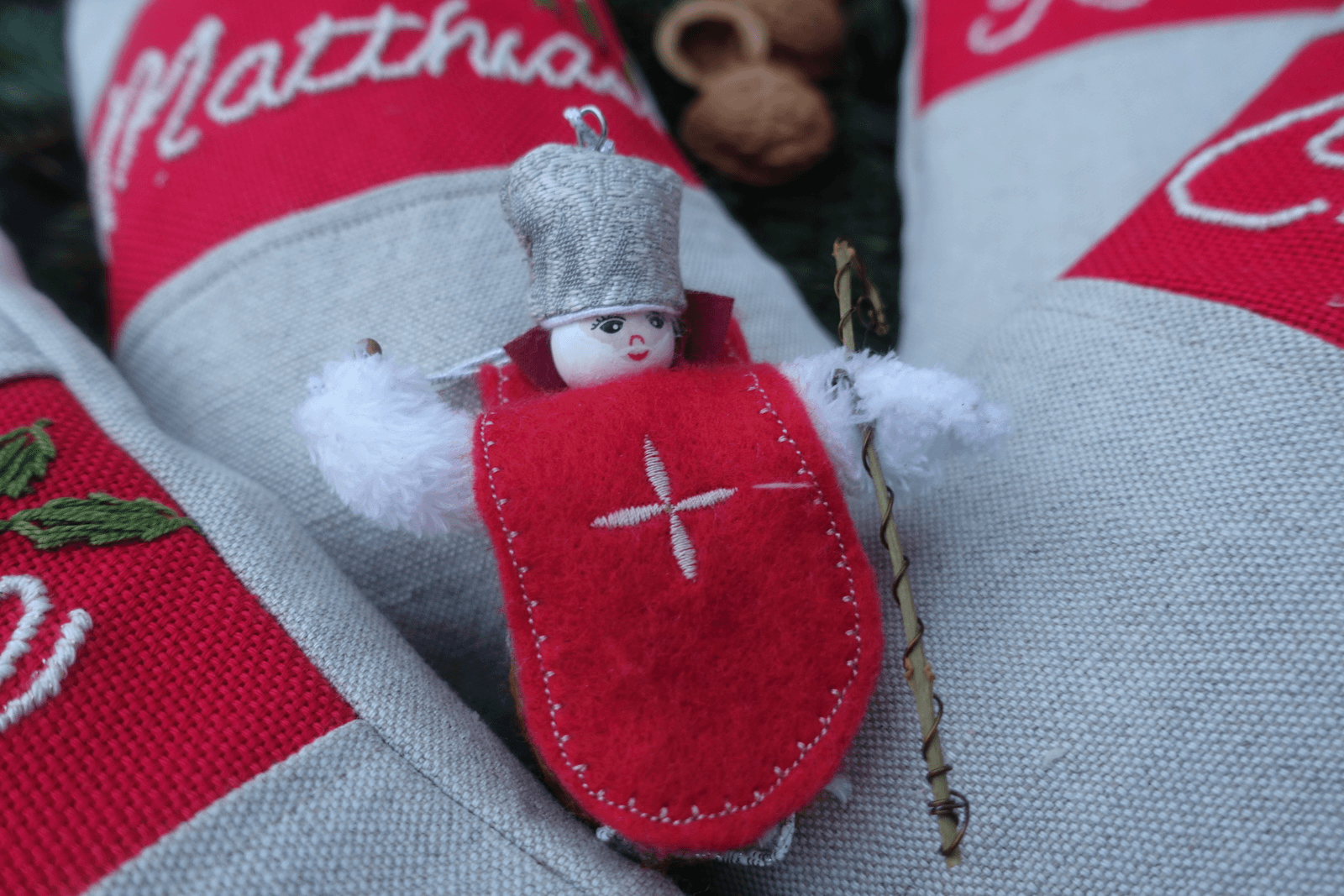 A walnut ornament hiden beneath St. Nick's cape