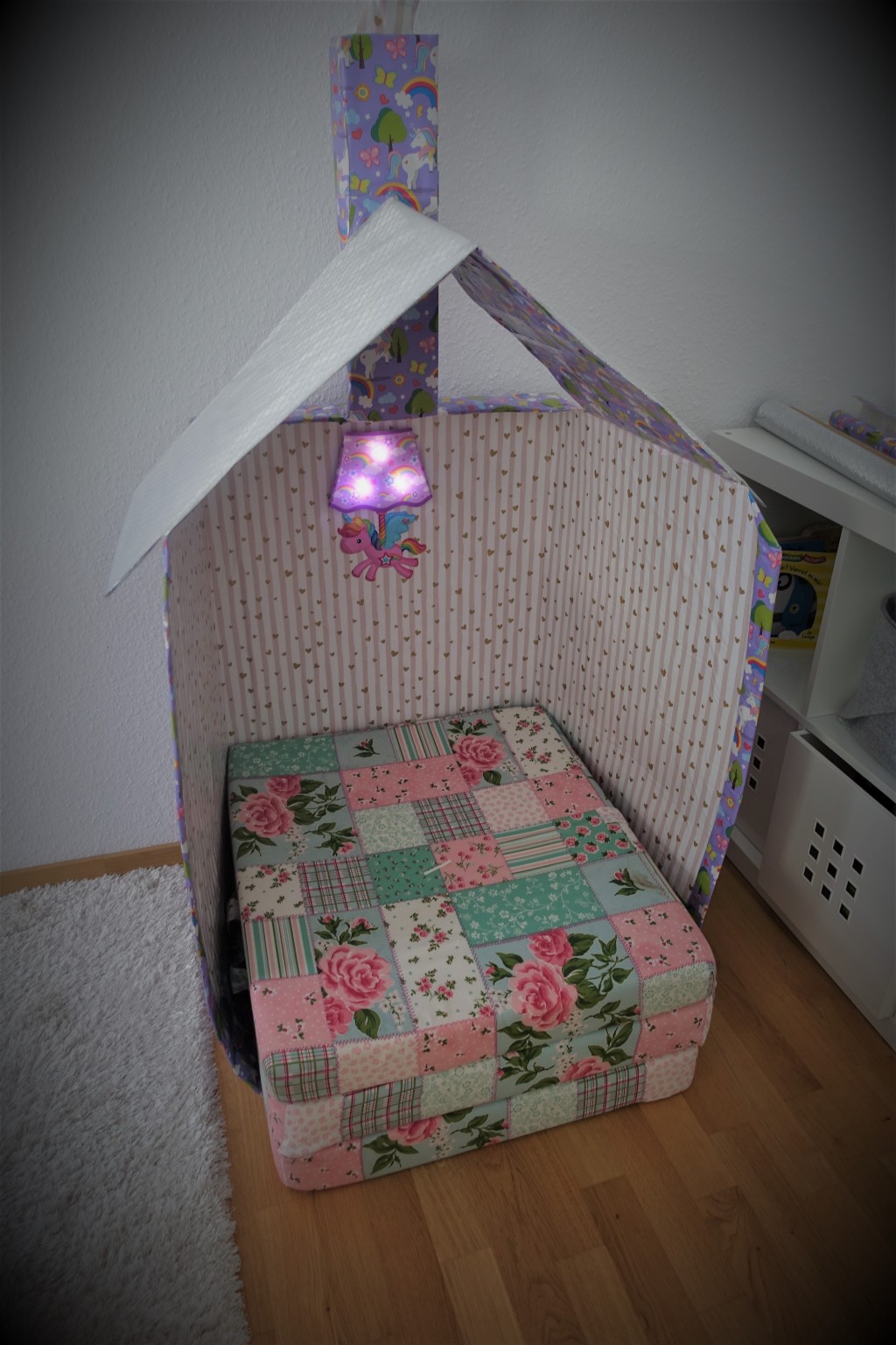 The final cardboard playhouse with a little lamp in the middle